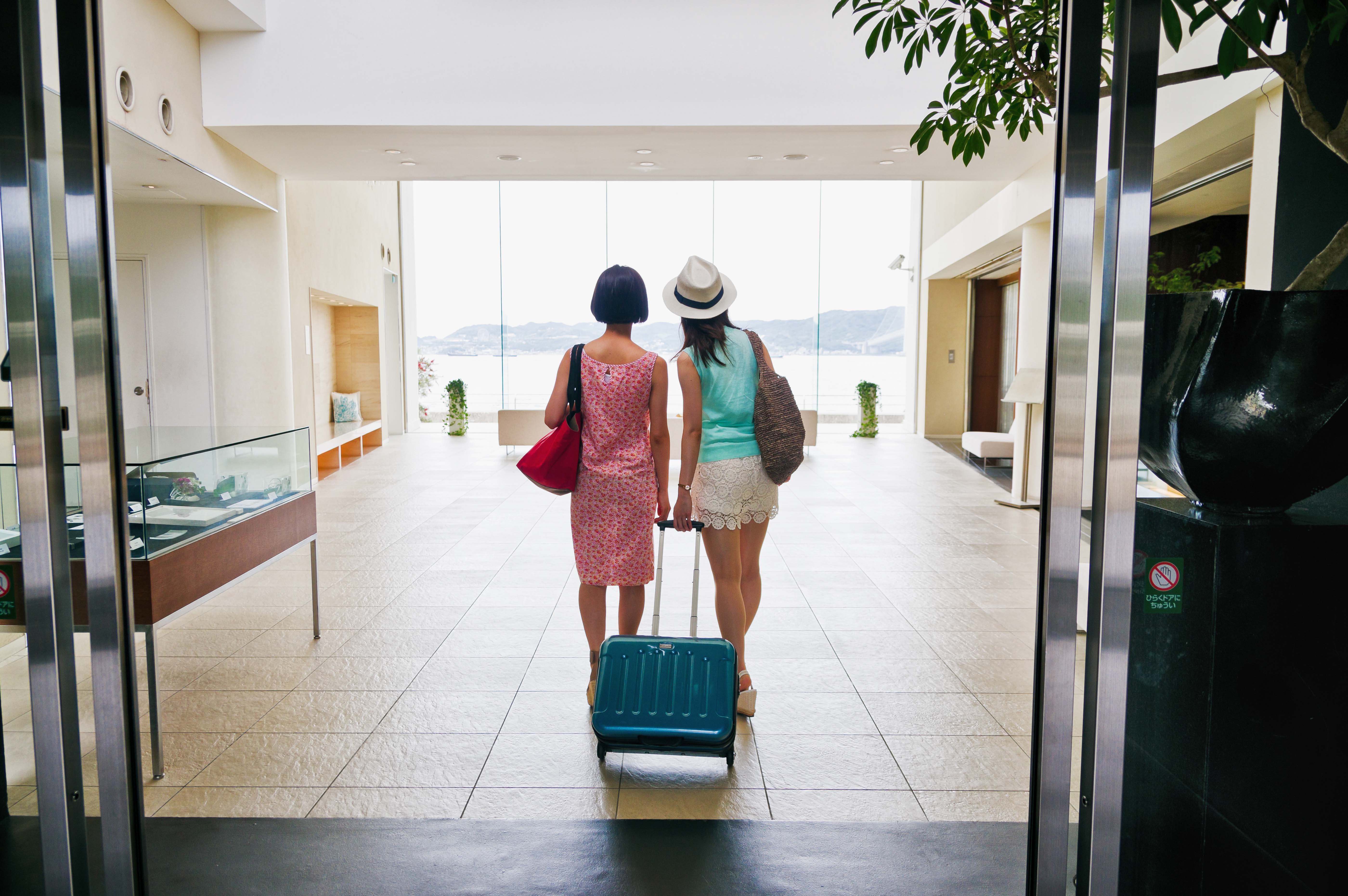 Back shot of two women entering the hotel